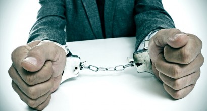 Businessman in handcuffs (Shutterstock)