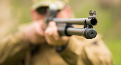 Man in military gear with shotgun (Shutterstock.com)