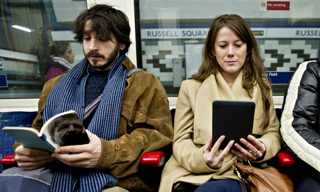 Woman reading an e-book on a tube train in London