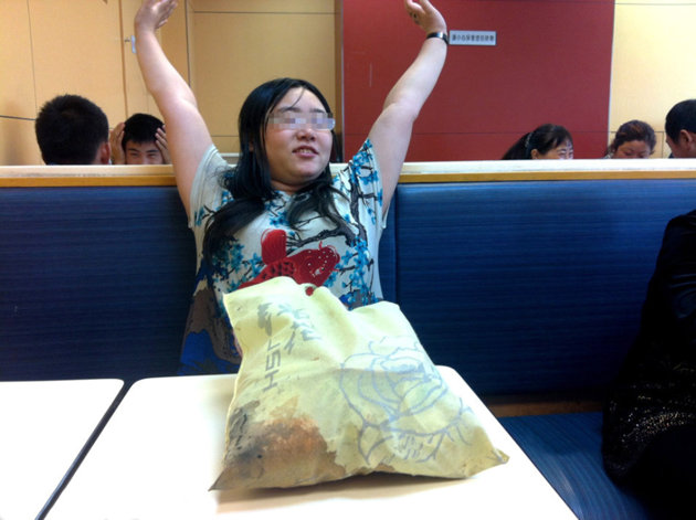 Depressed: Tan Shen makes herself at home in KFC. (CEN)