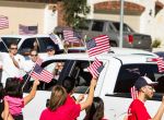 Staff Sgt. Travis Palmer and his family are greeted with flag-waving supporters as they arrive to a ceremony to officially give them their hew home on Wednesday, Oct. 22, 2014, in Tomball. "This is perfect," Sgt. Palmer said. "I can't ask for another single thing. This is home." The Palmers were given the keys to their newly-built, mortgage-free home, courtesy of H-E-B and Pulte Homes, in collaboration with local contractors and Operation Finally Home.