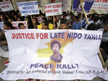 Members of the North East Students Organization (NESO) hold placards as they participate in a protest in Guwahati, India, Friday, Feb. 14, 2014. (AP Photo/Anupam Nath)