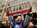 Paradegoers cheer during the annual Columbus Day parade with his daughter, Michaela, on Oct. 13, 2014, in New York City.  (Photo by Spencer Platt/Getty Images)