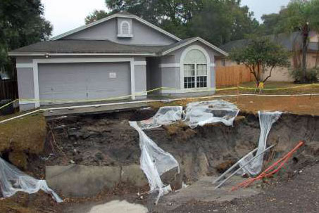 Picture of a sinkhole that formed below part of a house.