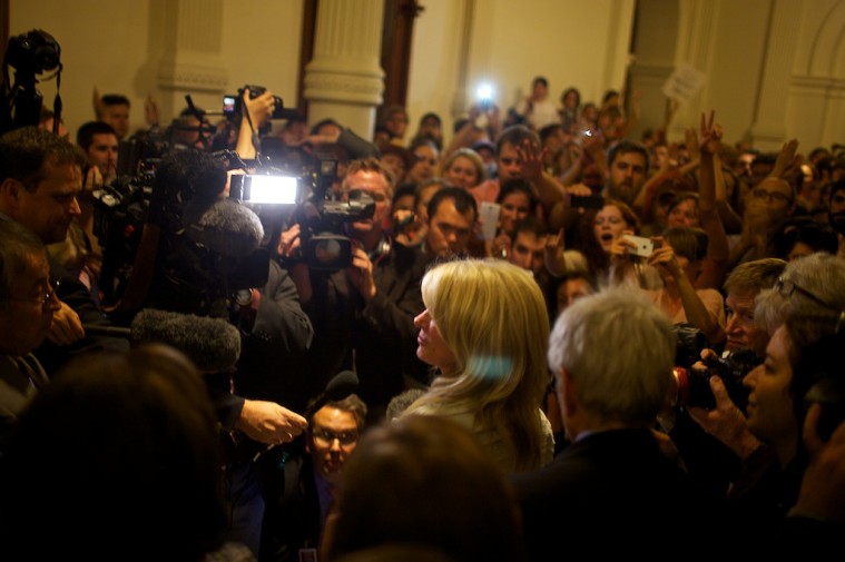 Sen. Wendy Davis speaks with the crowd outside the Senate chamber after stalling Senate Bill 5.