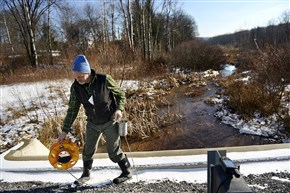 Department of Environmental Protection inspector John Sengle prepares to take water samples from Hawk Run near Philipsburg last January. The DEP is proposing a new policy to standardize the way it handles oil and gas well site inspections, enforcement actions and complaints that drilling has damaged water supplies. 