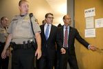 Governor Rick Perry is led into the booking area of the Travis County Courthouse for fingerprints and photographs on August 19, 2014.