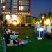 Brandon Neil, left, and Stacey Bran enjoy movie night in a courtyard of The Lotus, in Fairfax, Va.