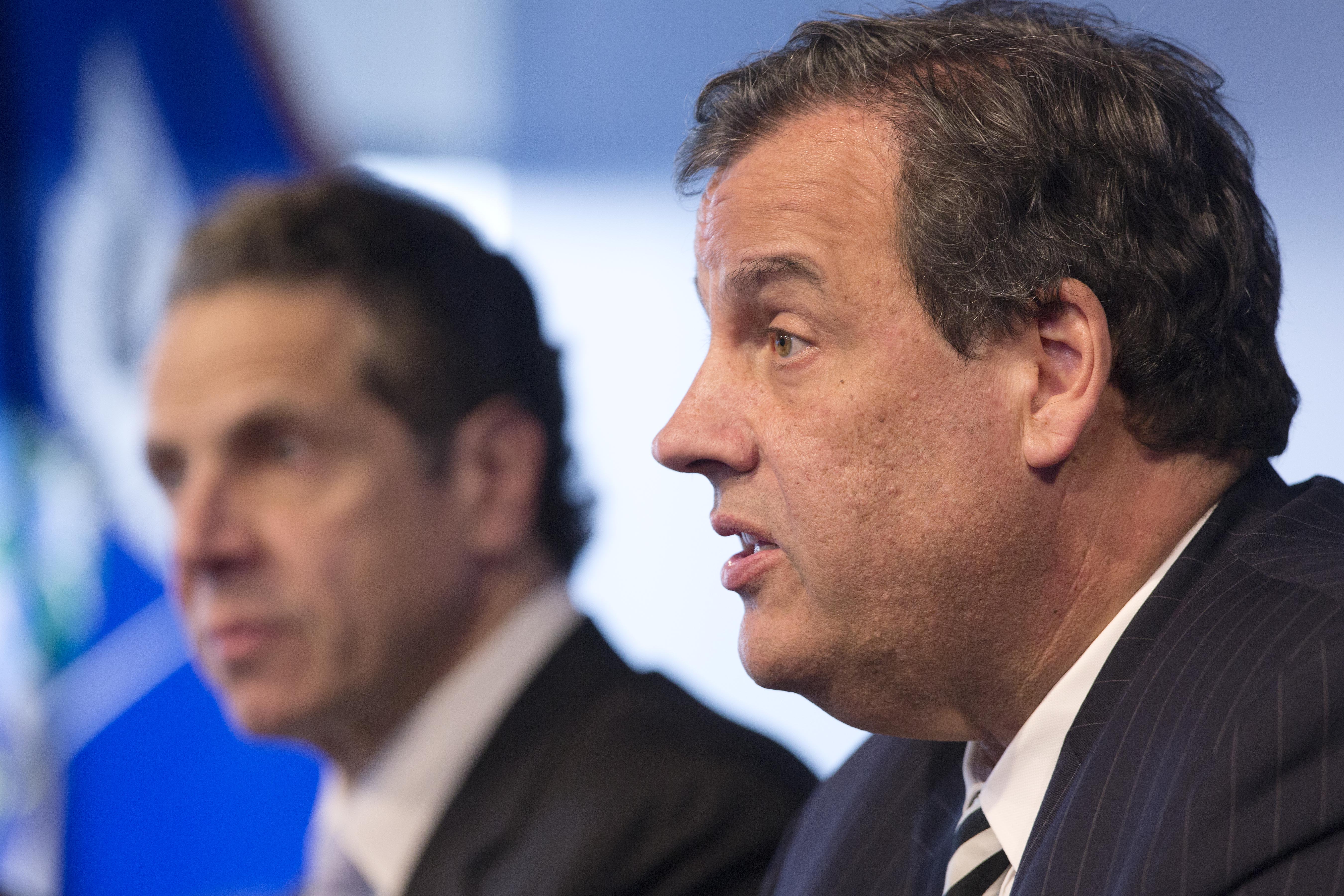 New York Governor Andrew Cuomo, left, listens as New Jersey Governor Chris Christie talks at a news conference on Ebola on Friday, Oct. 24, 2014 in New York. (AP Photo/Mark Lennihan)
