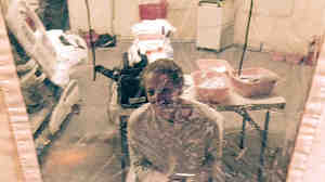 A photo taken Sunday of Kaci Hickox in an isolation tent at University Hospital in Newark, N.J. Hickox, who was later discharged and allowed to return to her home in Maine, says she has no intention of abiding by a "voluntary" quarantine there.