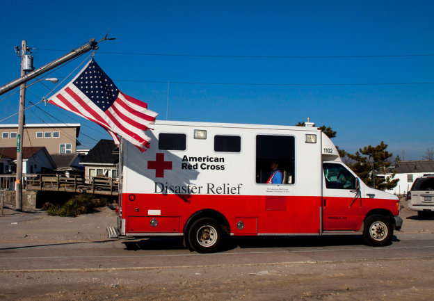 In the aftermath of Superstorm Sandy, a former Red Cross official says, as many as 40 percent of the organization's emergency vehicles were assigned for public relations purposes. This photo, which shows one of the trucks in Long Island, N.Y., in January 2013, is one example of the many publicity photos taken by the Red Cross. (Les Stone/American Red Cross)