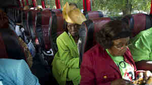 Martha Frazier rides a bus to vote in Miami in 2012. This year, Georgia churches are running similar "Souls to the Polls" programs, busing worshipers to early voting locations after Sunday service.
