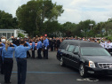 Pallbearers remove the  casket from the hearse. (Source: CBS4)