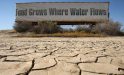 A sign on a farm trailer reading 'Food grows where water flows,' hangs over dry, cracked mud at the edge of a farm April 16, 2009 near Buttonwillow, California. Central Valley farmers and farm workers are suffering through the third year of the worsening California drought with extreme water shortages and job losses. The office of California Gov. Arnold Schwarzenegger predicts Central Valley farm losses of $325 million to $477 million and total losses for crop production and related business to be between $440 and $644 million. Central Valley is expected to lose 16,200 to 23,700 full-time jobs and food prices are expected to rise nationwide. (Photo by David McNew/Getty Images)