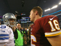 Tony Romo and Colt McCoy greet each other after the Redskins defeated the Cowboys 20-17 in overtime.  (Photo by Ronald Martinez/Getty Images)