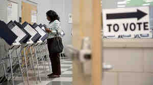 A voter casts her ballot at a polling site for Georgia's 2014 primary election in Atlanta.
