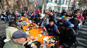 The homeless and others in need enjoy lunch at the Los Angeles Mission on Nov. 23, 2011, in celebration of Thanksgiving. Legislation to ban organizations from serving food to homeless people in public places has been proposed in Los Angeles.
