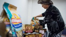 Brenda Craig of Texas Brew Salsa prepares her wares for the Go Texan Product Showcase on Tuesday at NRG Center. The event, sponsored by the Texas Department of Agriculture, gives Texas-based vendors a chance to do business with major retailers.﻿