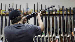 A customer checks out a shotgun at a store in College Station, Texas.