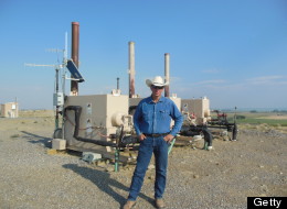 John Fenton, a local farmer, stands next to an Encana Corp. gas well near his home in Pavillion, Wyoming, U.S., on July 5, 2012. (Photo: Mark Drajem/Bloomberg via Getty Images)