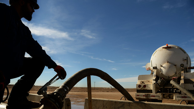 Sam Ramirez of Bonanza Creek, who has a major oil and gas lease on 70 Ranch in Weld County, fills his water truck so he can do dust control on the road in the ranch near Kersey, Colorado, on Oct. 23, 2014. Fracking operations on the ranch are in full swing.