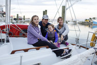 Jarad and Christel Astin, both 39, with their children Arden, 13, and Riley, 3, on their boat, named Catherine.