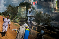 The reflection on an ambulance window of an Ebola outreach team in Kakata, Liberia.