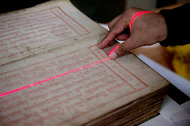 PRESERVED A newly discovered volume of a Tibetan Buddhist sacred text being scanned at the E. Gene Smith Library in southwest China.
