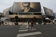 A giant canvas of the official poster of the 67th Cannes Film Festival featuring the actor Marcello Mastroianni at the entrance of the Festival Palace.