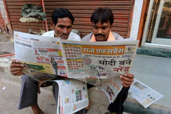 Men reading a Hindi-language regional newspaper in Bhopal, Madhya Pradesh, on May 27.