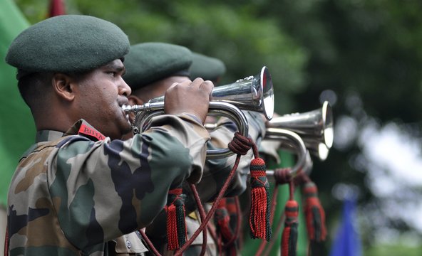 Soldiers paying tribute to military personnel who died during World War II at a memorial ceremony at the Imphal War Cemetery in Manipur.