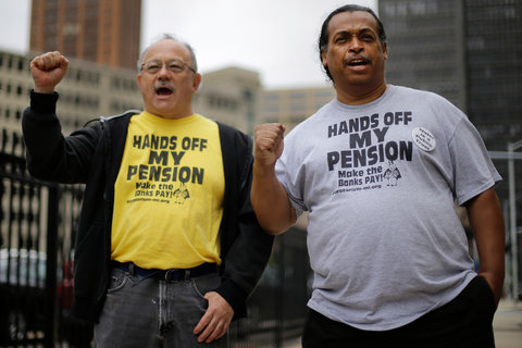 Two retired Detroit workers, William Davis, right, and Mike Shane, left, protested cuts in July.