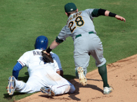 Eric Sogard of the Oakland Athletics runs down Elvis Andrus of the Texas Rangers in the sixth inning at Globe Life Park in Arlington on September 28, 2014 in Arlington, Texas. (credit: Rick Yeatts/Getty Images)