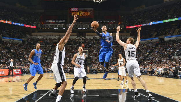 The Mavs' Monta Ellis goes for a lay up against the Spurs during the season opener.  (Credit: Jesse Garrabrant/NBAE via Getty Images)