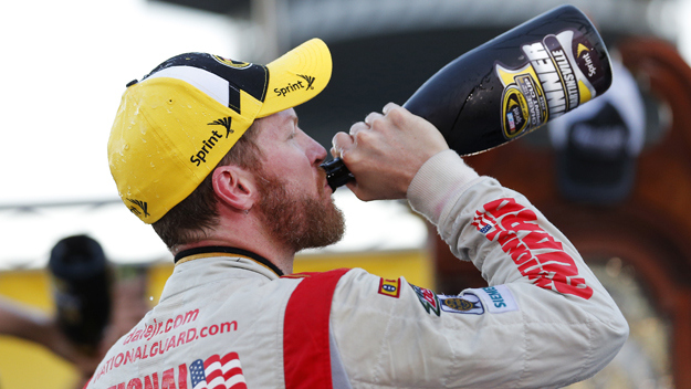 Dale Earnhardt Jr., driver of the #88 National Guard Chevrolet, celebrates in Victory Lane with champagne after winning during the NASCAR Sprint Cup Series Goody's Headache Relief Shot 500 at Martinsville Speedway on October 26, 2014 in Martinsville, Virginia. (credit: Chris Trotman/Getty Images)