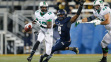MIAMI, FL - OCTOBER 18: Rakeem Cato #12 of the Marshall Thundering Herd is pursued by Giovani Francois #9 of the Florida International Panthers as he scrambles out of the pocket with the ball on October 18, 2014 at FIU Stadium in Miami, Florida.Marshall defeated Florida International 45-13. (Photo by Joel Auerbach/Getty Images)
