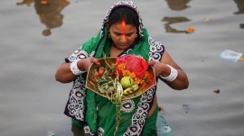 A Hindu devotee prays while standing in the waters of the Arabian Sea as she worships the Sun god Surya during the Hindu religious festival Chatt Puja in Mumbai October 29, 2014. REUTERS/Shailesh Andrade