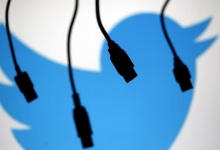 Electronic cables are silhouetted next to the logo of Twitter in this September 23, 2014 illustration photo in Sarajevo. REUTERS/Dado Ruvic