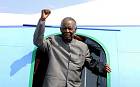Michael Sata gesturing upon his arrival at the Solwezi airport before an election campaign meeting in 2014