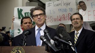 A defiant Texas Governor Rick Perry speaks to supporters after his booking at the Travis County Courthouse on August 19, 2014.