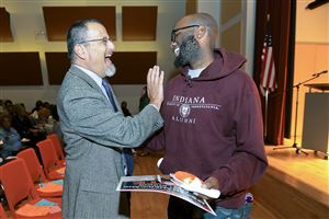  Richard Wertheimer, left, founder of City Charter High School, greets former student Darnell Campbell of Highland Park before a panel discussion about equity and excellence in education.