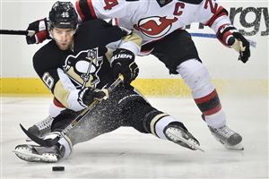 Penguins center Brandon Sutter is pulled down by the Devils' Bryce Salvador in the third period.