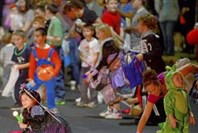  Children rush for candy during Bloomfield's 44th annual Halloween parade on Liberty Avenue in 2012.