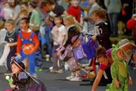  Children rush for candy during Bloomfield's 44th annual Halloween parade on Liberty Avenue in 2012.