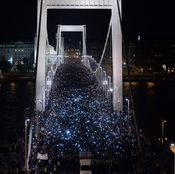 Thousands participants march accross the Elisabeth bridge during an anti-government rally against the government's plan to tax Internet usage.