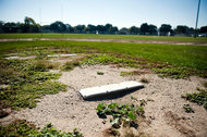 A field at Lloyd Barbee Montessori, a Milwaukee public school, reflects the poor state of many of the city’s playing surfaces and recreation centers.