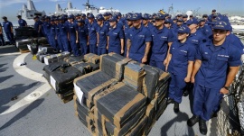 U.S. coast guard officers stand next to seized cocaine packages, on the deck of the U.S. Coast Guard Cutter Boutwell at Naval Base San Diego in San Diego, October 6, 2014. REUTERS/Mike Blake