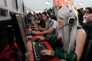 A group of people playing League of Legends at a gaming conference in Boston.