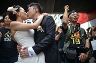 A couple posed for wedding photographs against a backdrop of pro-democracy protesters in Hong Kong on Oct. 1.