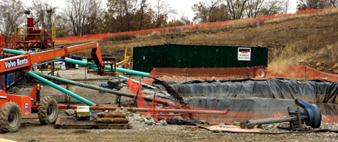 Fluids made up of a combination of naturally occurring water from the shale formation and drilling mud are pumped into a lined retaining area behind the drilling rig on a farm in Houston, Pa., in October 2008. New York state is currently holding a public comment period for an environmental review of natural gas drilling in the Marcellus Shale. (Keith Srakocic/AP Photo)